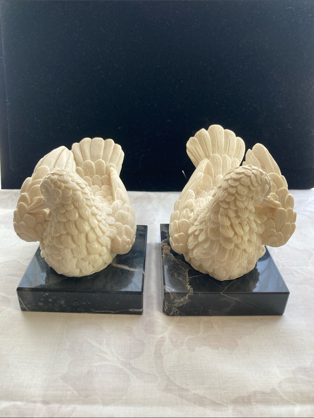 Pair of Carved Ivory-Color Birds on Black Marble Bases